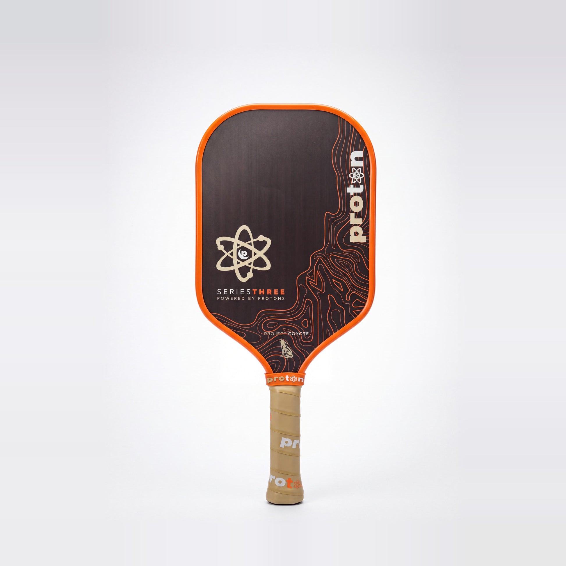 Proton Project Coyote Elongated 15mm pickleball paddle — front face, orange edge guard and tan grip